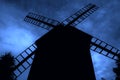 Old grain mill against the dark background. Royalty Free Stock Photo