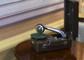 An old gramophone with the receiver removed on a wooden pedestal