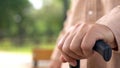 Old grandfather hand on walking stick close-up, social pension reforms, support Royalty Free Stock Photo