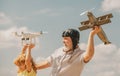 Old grandfather and young child grandson with plane and quadcopter drone over blue sky and clouds background. Men