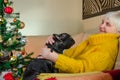 Old grandmother in new year hug, play with active black French bulldog. senior lady enjoy cheerful, young pet. granny in