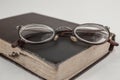 Old grandmother`s glasses and a dilapidated book