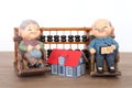 Old grandpa model and grandma model and small house model and calculation tool abacus Royalty Free Stock Photo