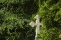 Old grave with cross on tombstone traditional European cemetery. Aged grave yard in forest Royalty Free Stock Photo