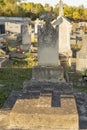 Old grave decorated with a large cross, in a cemetery