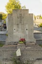 Old grave decorated with a large cross, in a cemetery