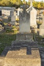 Old grave decorated with a large cross, in a cemetery