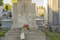 Old grave decorated with a large cross, in a cemetery