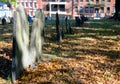 Old gravestones made of slate seen within a Boston, USA graveyard in late autumn.