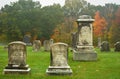 Old gravestones in a New England cemetery on a misty autumn morning