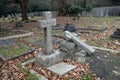 Old Graveyard with Broken and Fallen Crosses and Graves in Overgrown Grass Spooky