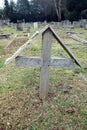 Old Graveyard with Broken and Fallen Crosses and Graves in Overgrown Grass Spooky