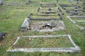 Old Graveyard with Broken and Fallen Crosses and Graves in Overgrown Grass Spooky