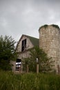 Old, Gray, Abandoned Barn and Overgrown Silo Withs Royalty Free Stock Photo