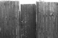 Old gray black  rural wooden fence with a closed door Royalty Free Stock Photo