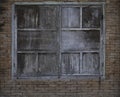 Weathered closed old wooden shutters on old brick background