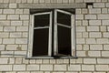 Old gray broken open window on brick wall building Royalty Free Stock Photo