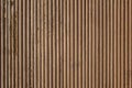 Old gray brown beige wavy wooden surface with peeling paint and vertical lines. rough texture