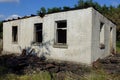 Old gray burnt brick house with empty black windows Royalty Free Stock Photo