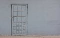 Old gray door in concrete wall