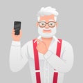 Old gray-haired bearded grandfather in glasses points to a smartphone in his hand. Happy elderly man with phone. Successful