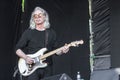 Old gray-haired rocker with bass guitar