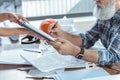 Old gray-haired worker is filling papers for female Royalty Free Stock Photo