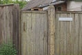 Old gray rural wooden wall fence with a closed door Royalty Free Stock Photo