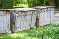 Old gray rusty mail boxes in empty garden yard with green grass Royalty Free Stock Photo