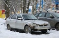 An old gray rusty wrecked car is parked in the yard in the snow Royalty Free Stock Photo