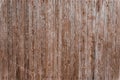 Old gray with shabby brown paint a wooden fence, aged background and texture. Rustic wooden fence plank. natural patterns backgrou Royalty Free Stock Photo