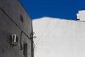 Old gray stucco building wall on the background of blue sky, city abstract Royalty Free Stock Photo