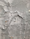 Old gray wall with cracks in plaster and paint. Destruction