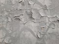 Old gray wall with cracks in plaster and paint. Destruction of graffiti