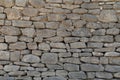 Old gray wall made of large and small rectangular hewn natural stones Royalty Free Stock Photo