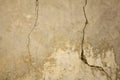 A old gray white concrete wall with deep and small cracks. rough texture. Royalty Free Stock Photo