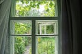 Old gray window with curtains in the room on a bright summer day Royalty Free Stock Photo