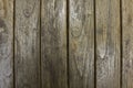 A old gray wooden fence boards. vertical lines. natural surface texture Royalty Free Stock Photo