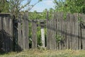 Old gray wooden fence with broken boards Royalty Free Stock Photo