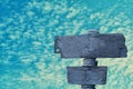 Old gray wooden sign  with  blue sky background Royalty Free Stock Photo