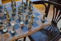 Old Greek chess figures on an antique chessboard