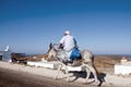 Old greek man in saddle to his donkey Royalty Free Stock Photo
