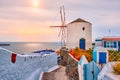 Old greek windmill on Santorini island in Oia town with stairs in street. Santorini, Greece