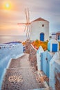 Old greek windmill on Santorini island in Oia town with stairs in street. Santorini, Greece Royalty Free Stock Photo