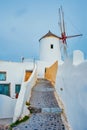 Old greek windmill on Santorini island in Oia town with stairs in street. Santorini, Greece Royalty Free Stock Photo