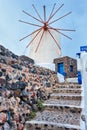 Old greek windmill on Santorini island in Oia town with stairs in street. Santorini, Greece Royalty Free Stock Photo