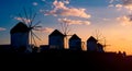 Old greek windmills on Mykonos island at sunset Royalty Free Stock Photo