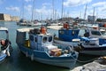 Old Greek wooden fishing boats with white and blue hulls in port of Heraklion. Royalty Free Stock Photo