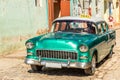 Old green american retro taxi car on the street of Trinidad, Cuba Royalty Free Stock Photo