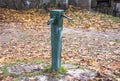 Old green antic water pomp